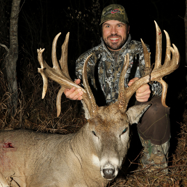 Hunter proudly displaying an non-typical deer showcasing a successful bow hunt harvest