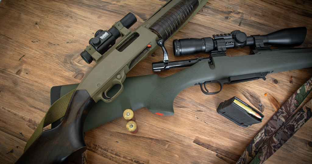 Shotgun and rifle laid out on a table for comparison