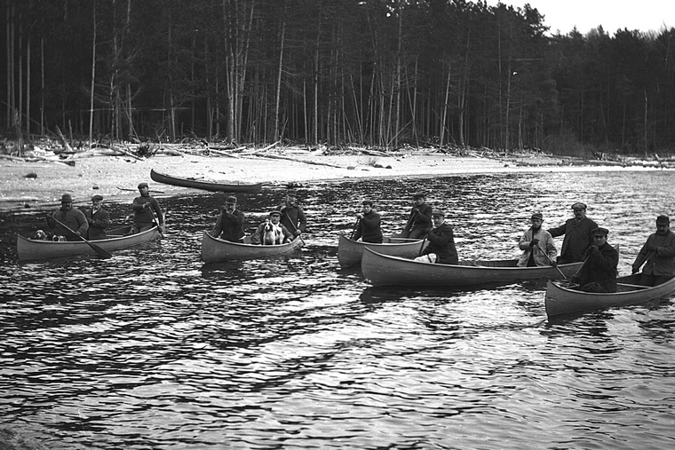 Hunt club members arriving at camp by canoe