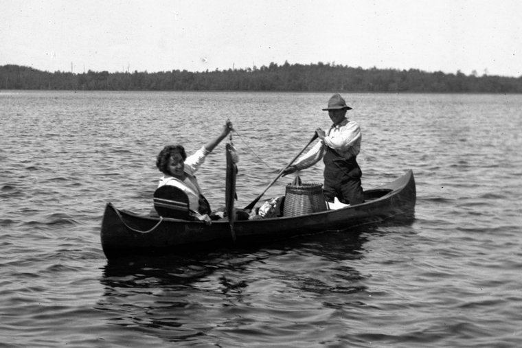 A woman with a muskie and her Indigenous guide.