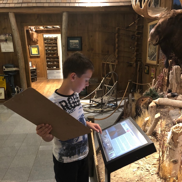 Child viewing a display screen at the OFAH | Mario Cortellucci Hunting and Fishing Heritage Centre