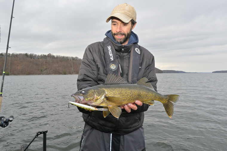 Angler with walleye from cool clear water