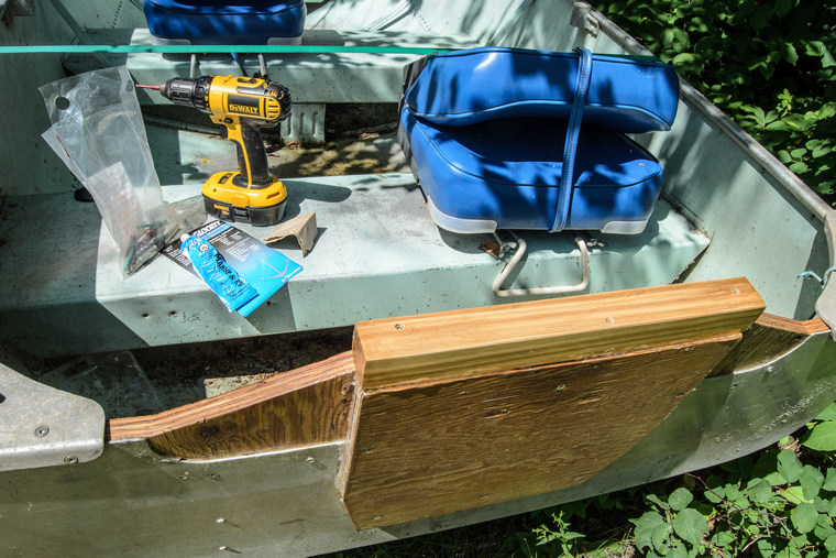 tin boat with repaired transom and tools