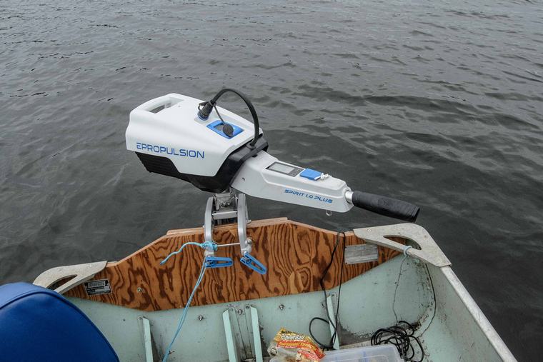 tin boat with repaired transom and electric motor.
