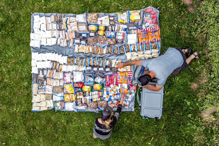 couple prepare food for a wild adventure