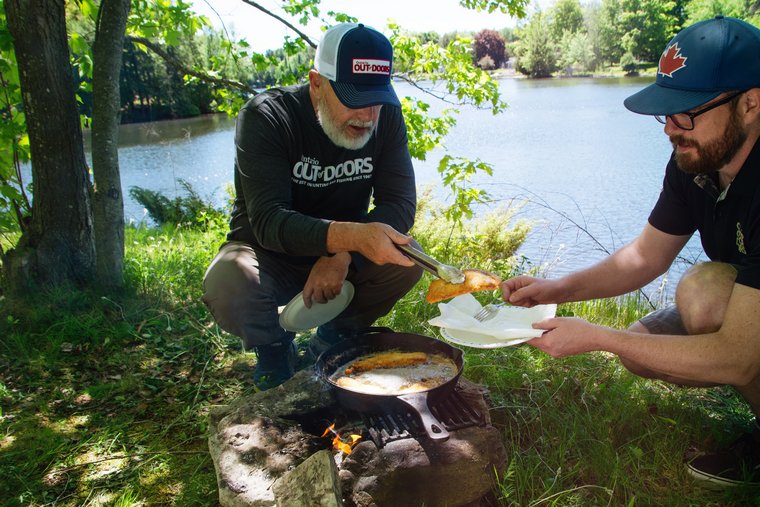 anglers preparing a shore lunch of fried fish