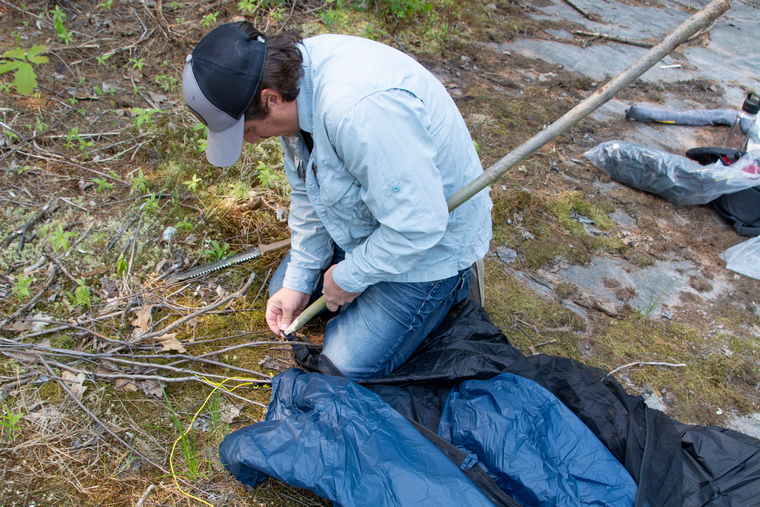 hunter pitching a tent
