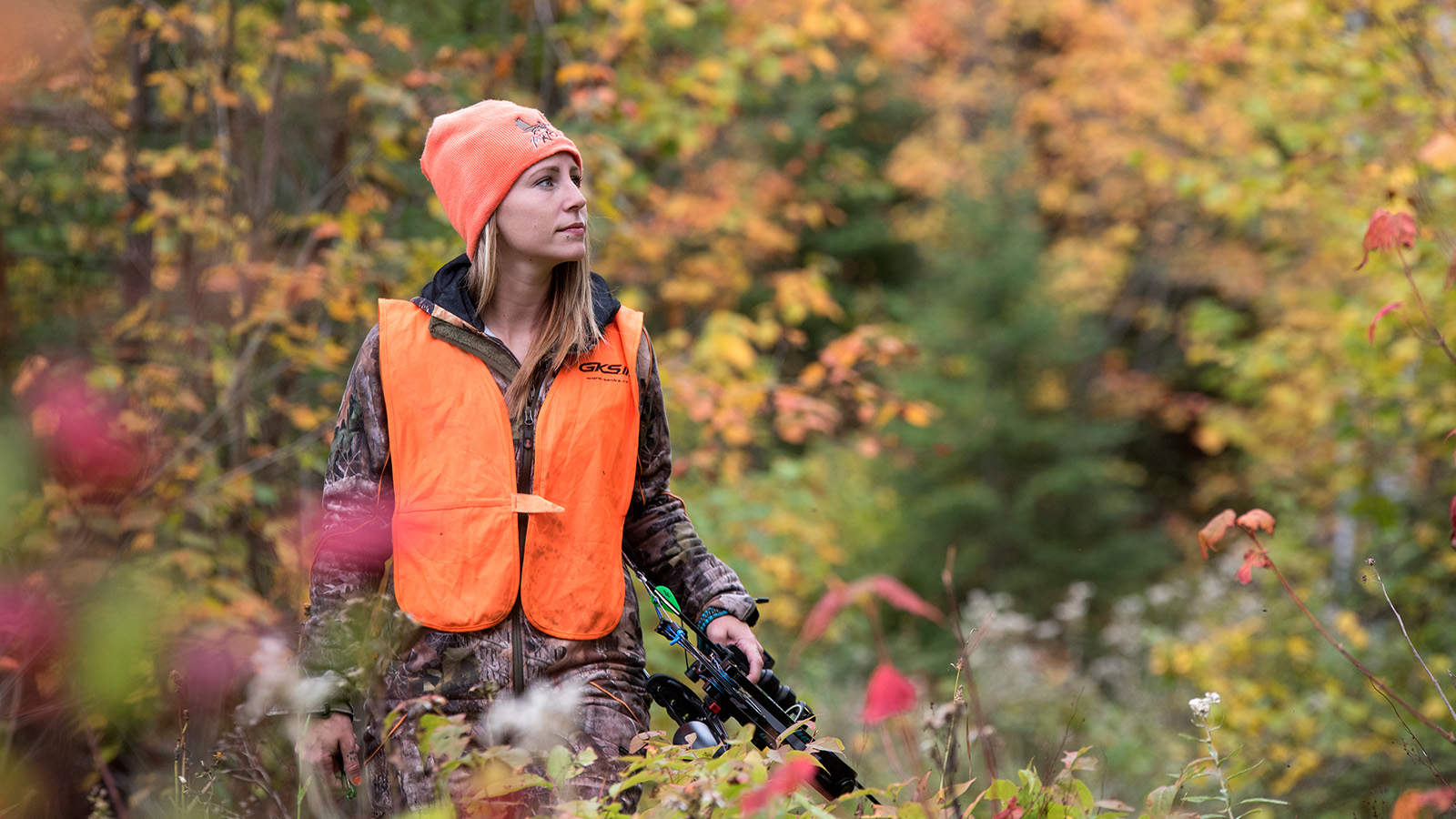 Crossbow hunter in hunter orange in the forest